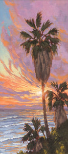 Sunshine creeps around the edges of a palm tree at sunset. Swami's Beach, Encinitas, Califonia